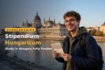 Student holding a Stipendium Hungaricum scholarship award letter in Budapest, Hungary
