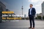 Professional man standing in Berlin with the TV tower behind him — jobs in Germany for foreigners work visa and EU Blue Card guide